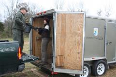 Image of Beth Ciuzio (right) of the US Fish and Wildlife Service hands off a truckfull of trees to Fred Tenore of Hillsborough Township's Parks and Recreation Department.