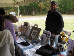 Image of Ben Wurst mans a CWF table at an event at Forsythe NWR in Oceanville.